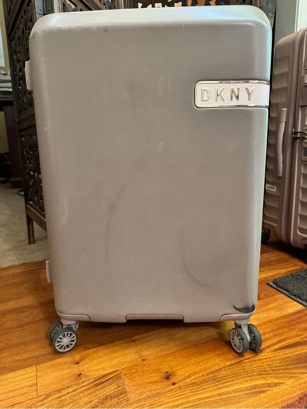 DKNY expandable Tan and Pink roller luggage with gold accent hardware